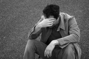 Man holds his head down in sadness